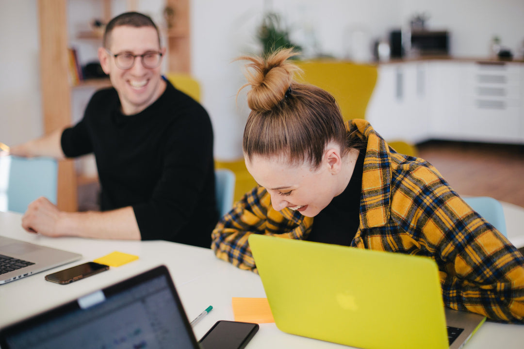 Coworkers sitting at table laughing