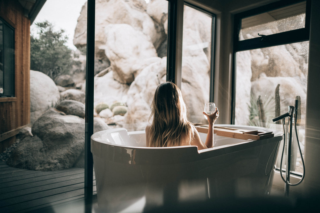 woman in bathtub with mountains in background