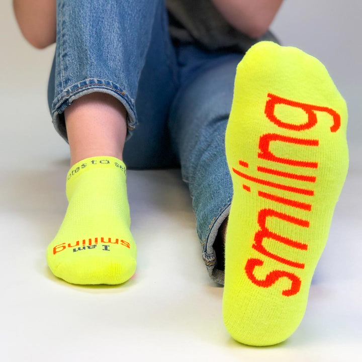 i am smiling neon yellow socks with positive message